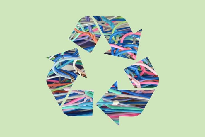 wire hangers in a recycle symbol on a green background