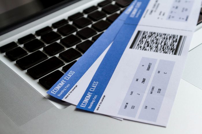 Airline tickets over the keyboard of a laptop