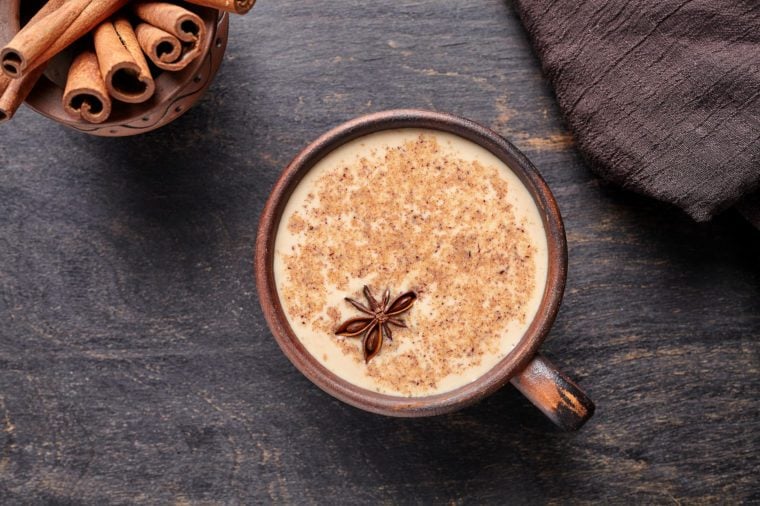 milky tea latte with spices and cinnamon sticks