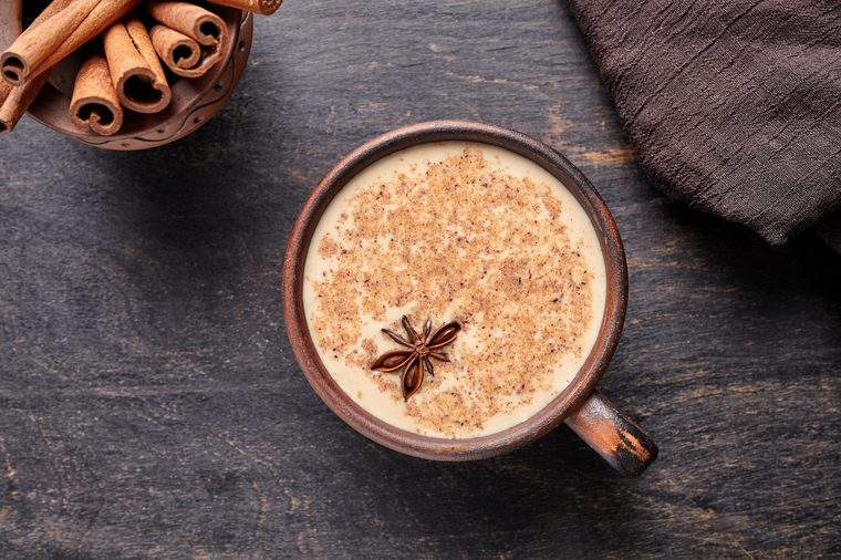 milky tea latte with spices and cinnamon sticks