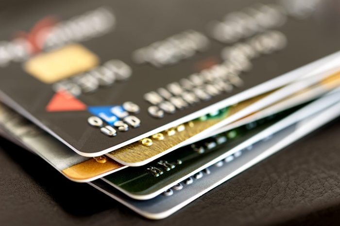 Credit card close-up. Plastic card on black background