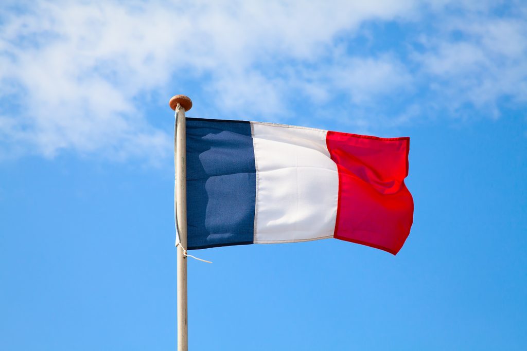 French flag in the blue sky