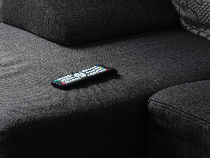 Tv Remote on gray sofa