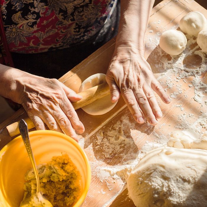 Senior woman hands rolling out dough in flour with rolling pin in her home kitchen; Shutterstock ID 295375742; Job (TFH, TOH, RD, BNB, CWM, CM): TOH