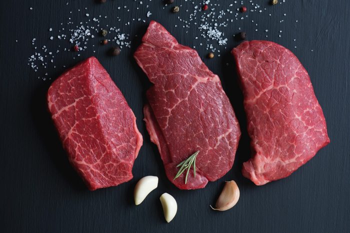 Top view of black angus beef steaks with seasonings, studio shot