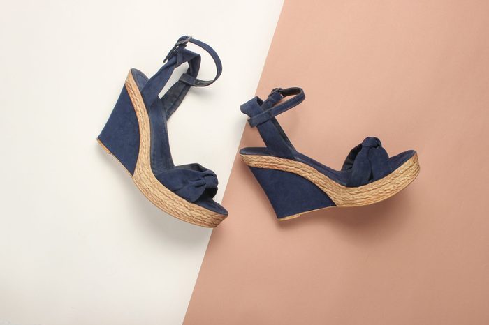 Female sandals on a platform on a colored paper background. on form. Fashionable summer shoes