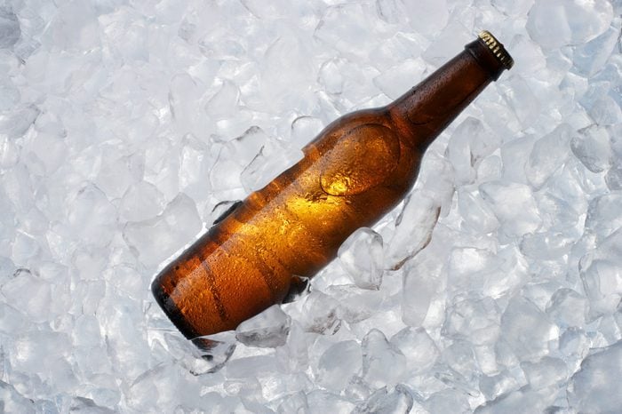 A brown bottle on ice