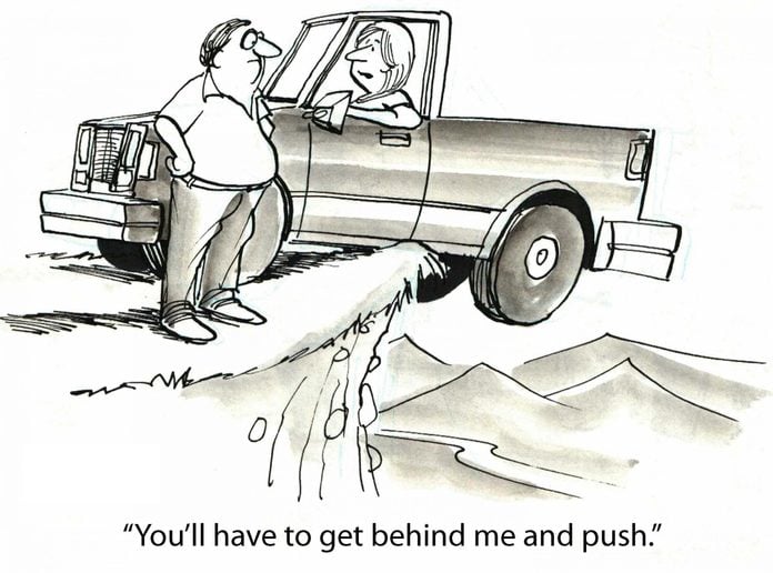 Cartoon showing a truck dangling off a cliff, a woman is in the truck and says to man standing on cliff, 'You'll have to get behind me and push'.