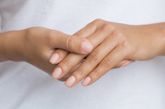 Nude Nails. Woman Showing her Manicure, Holding Hands Together