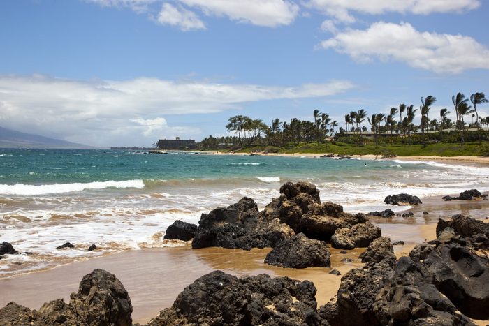 Surf crashing against rocks on a beach in Wailea, Maui, Hawaii