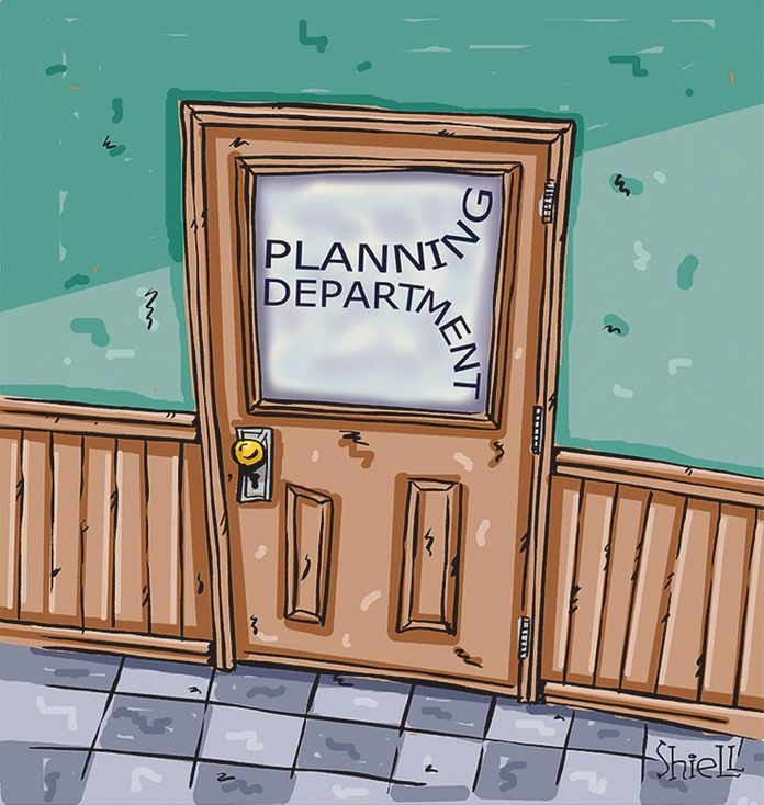 door with a glass panel that reads "planning department" written as if the writer ran out of room for all the letters