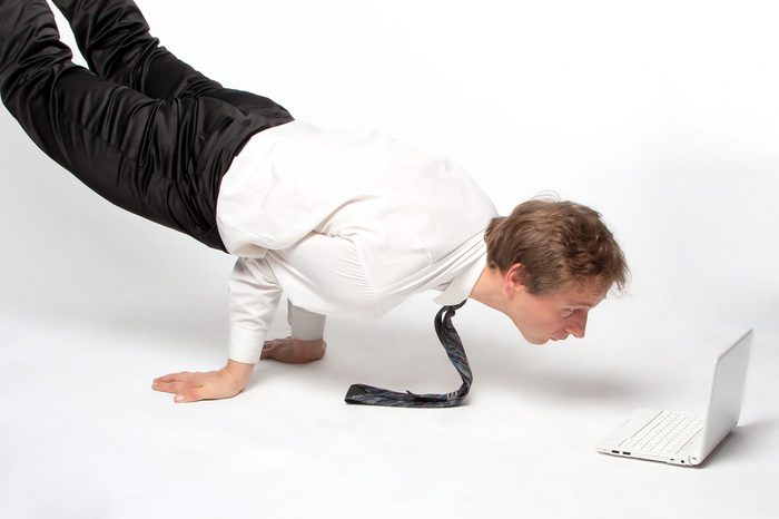 Young businessman yoga before an open notebook