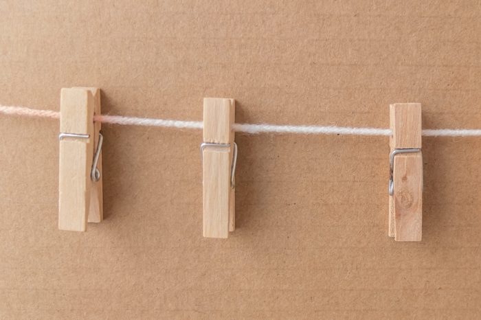 clothespins attached to a rope on brown paper background with clipping path