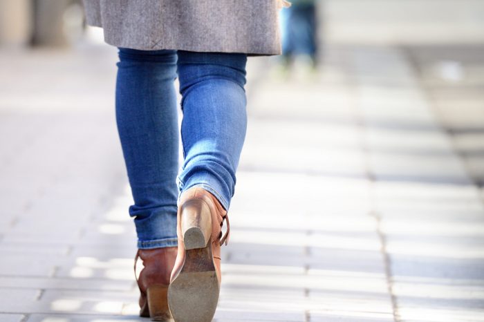 Woman walking on sidewalk