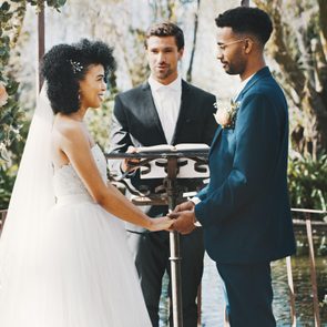 couple standing at the altar with the officiant during their wedding ceremony