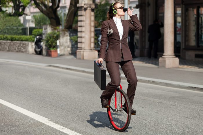 woman through the city with the unicycle to go to work, outdoor