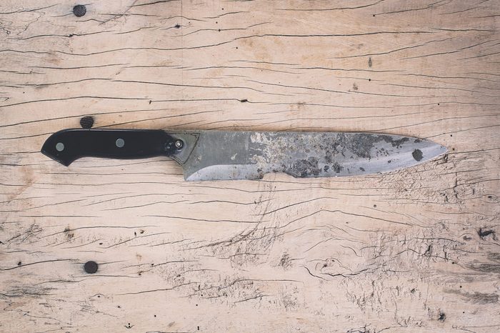 wood cutting board and rusty knife