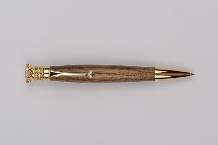 Exotic, Luxury Iroko wood bolt-action pen with chrome metal fixtures and beautiful knot in the wood - Product Photo Ballpoint Pen Handmade Hand Crafted.