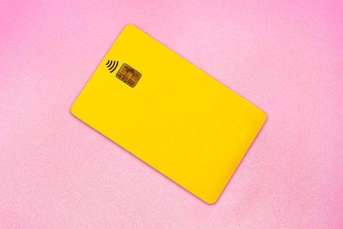 yellow credit card on pink background