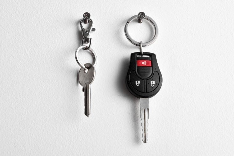 Car and house keys hanging on wall