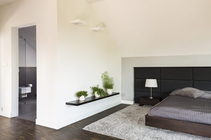 Shot of a spacious modern bedroom connected to a bathroom