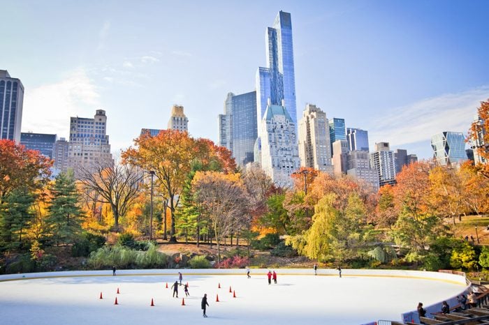 Ice skaters having fun in New York Central Park in fall 