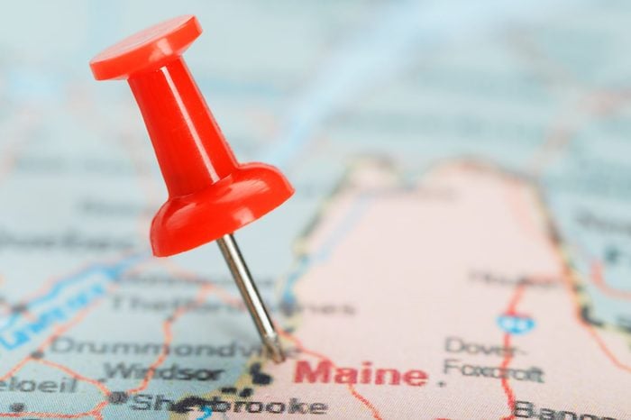 Red clerical needle on a map of USA, South South Maine and the capital Augusta. Close up map of South South Maine with red tack