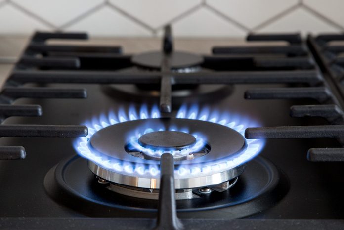 Gas burner on black modern kitchen stove. kitchen gas cooker with burning fire propane gas