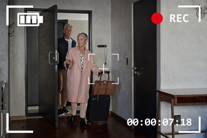 senior couple arriving in their vacation rental with camera viewfinder overlay