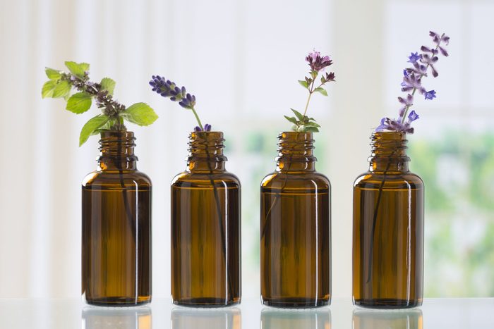 brown bottle with aromatic herbs for essential oil