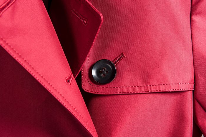 Partial close-up of neckline of red trench coat