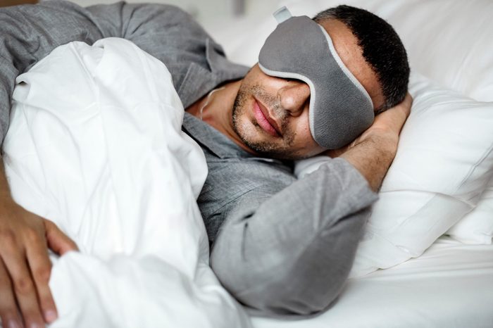 man sleeping bed eye sleep mask