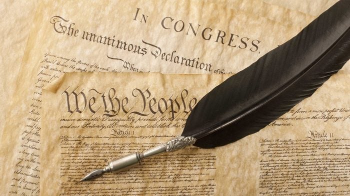 The Constitution for the United States of America with a quill pen