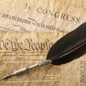 The Constitution for the United States of America with a quill pen