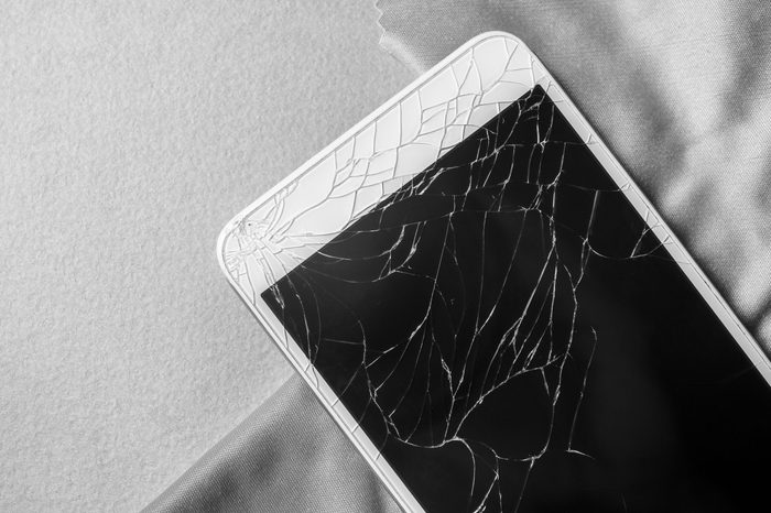 Broken mobile phone screen, close-up, black and white frame
