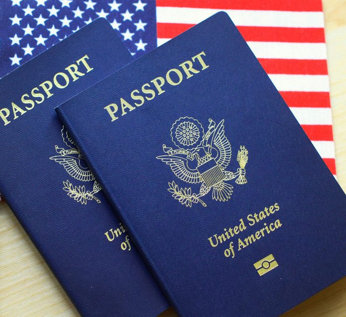US passports on american flag