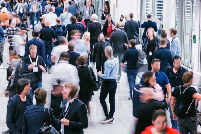 Crowd of anonymous blurred people at a trade show
