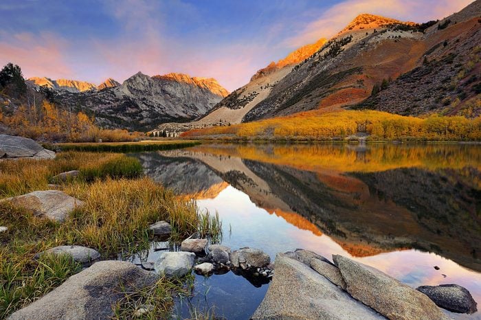 Small Sierra Nevada lake reflection spectacular fall color at dawn.