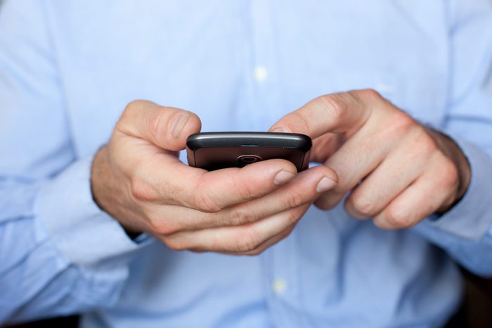Close up view of a businessman using a smartphone