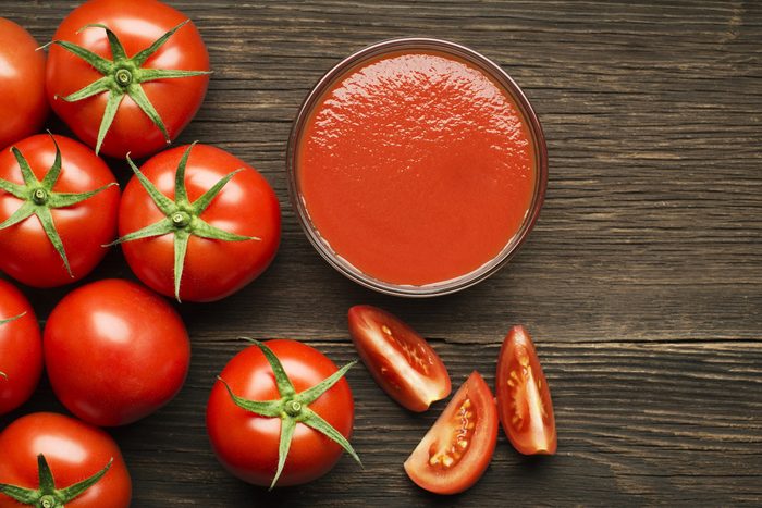 Fresh cherry tomato sauce on rustic wooden background