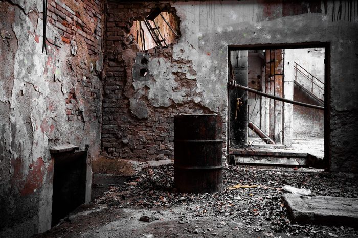a desolate old industrial building inside, barrel