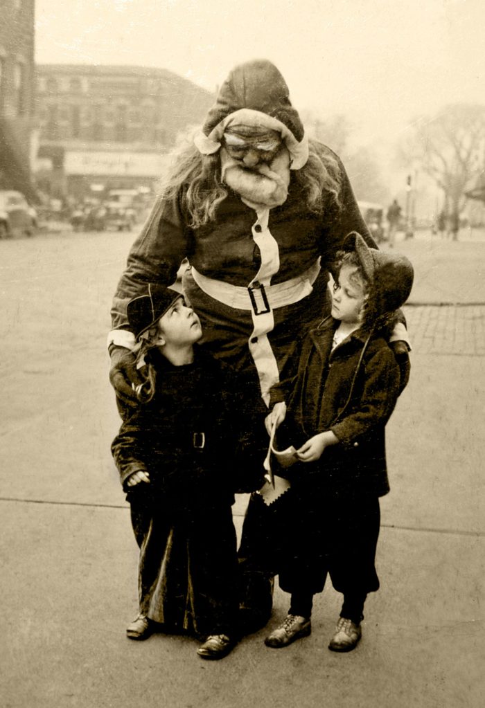I am originally from Ottawa, Ill., and my Grandpa Brown used to dress up as Santa and go around the neighbor hood handing out candy to the kids. I found this old photo in my family Bible and thought I would share it. Sorry, I don't know who the two young girls are with Grandpa (Santa) but perhaps someone may remember this and identify who they may be. It must have been taken around 1947-1950 as after that period, my family moved to California. The photo was in the local newspaper along with a short written piece. My Grandpa Brown was a business man in the 30's and 40's in Ottawa. The article went like this: "Santa Claus has made his last round in the Northwest section of Ottawa but the small frys of the District are confident that someone will replace him and his manner will be as jolly, his supply of candy as ample and his handshake as hearty as that of the Santa Claus who will not be on hand again this year. The real Santa Claus in this area was Edward D. Brown, a big man with a heart to match. He died this past month. For 20 years come Christmas, Brown found funds to buy candy for the small ones of the area, put on his suit and go north on his rounds. He was a neighborhood tradition.
