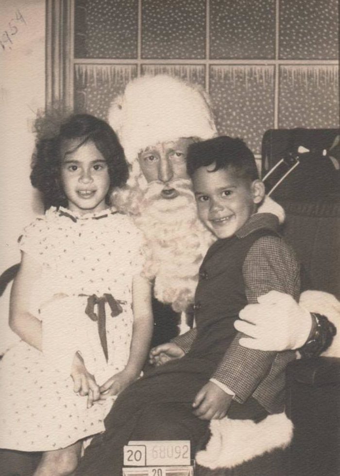 Childhood Christmas experiences are incomplete without a visit to the department store Santa Claus! Here my siblings; Olga and Ruben Garcia; 7 and 5; are all smiles while perched on Santa's lap. The photo was taken in San Francisco; California; in 1954. I was actually already two years old at the time; but was so terrified of Santa that my one and only picture with him was taken when I was eight. After that; I felt I was too old to sit on his lap.
