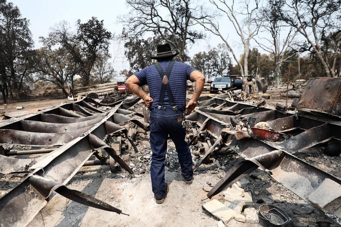 Ed Bledsoe stands on the wreckage of his family's home