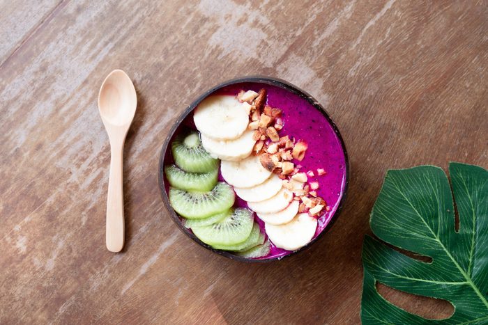 Smoothie bowl with fresh fruits,kiwi, banana and homemade granola almond for healthy vegan vegetarian diet breakfast.