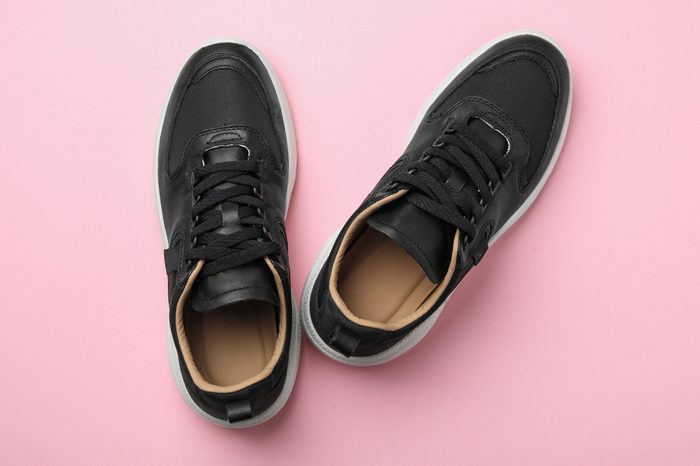 Pair of stylish shoes on pink background, top view