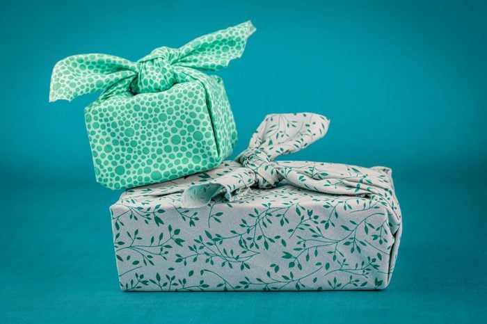 Fabric wrapped gifts, reusable sustainable recycled textile gift wrapping alternative zero waste concept