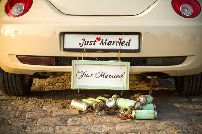 Wedding car with a plate "Just married" and a bunch of a beer cans.