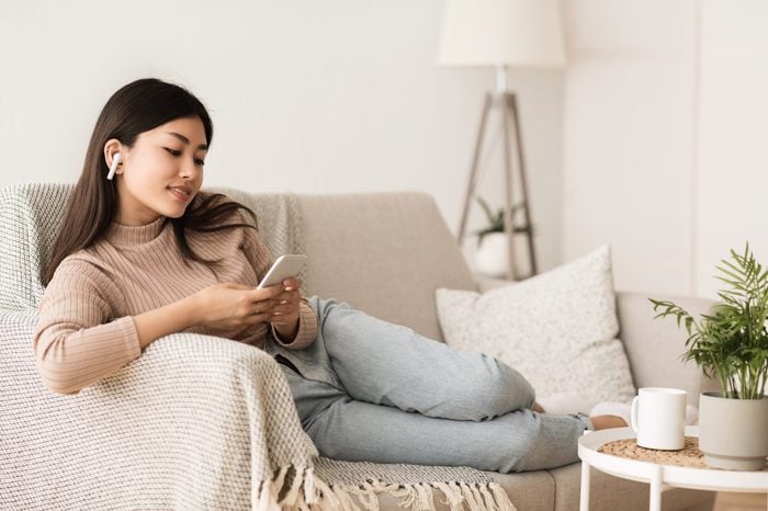 Time to Relax. Asian Girl in Airpods Listening Music Online on Smartphone, Copy Space
