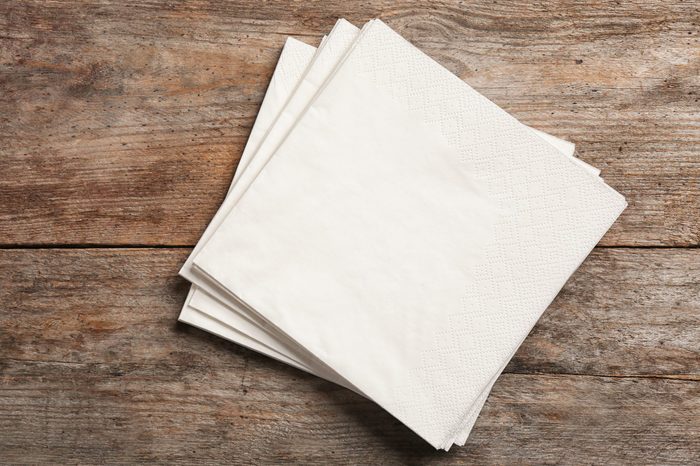 Clean napkins on wooden background, top view with space for text